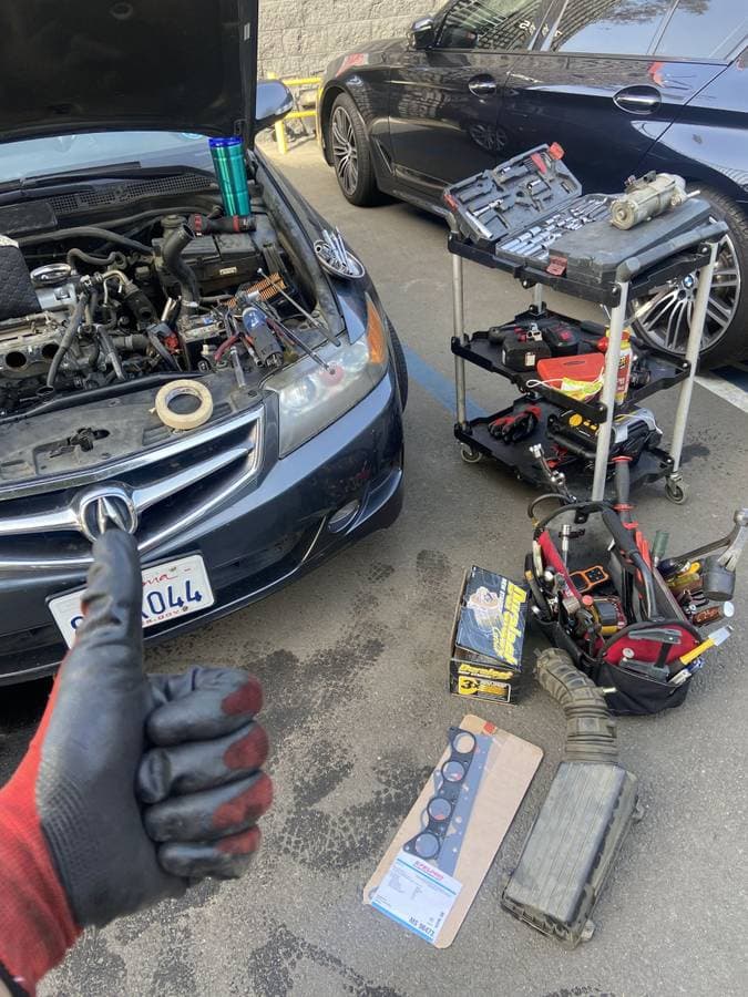 Mechanic doing a head gasket job on a car